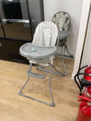 a baby high chair and a fire extinguisher in the kitchen