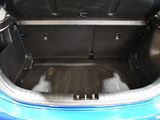 a blue car with its trunk open on the street