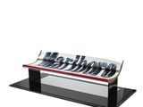 an image of a glass bench with metal letters on it