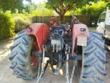 a tractor that is parked next to a truck