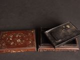 two small wooden boxes sitting on top of a black surface