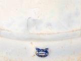 a white vase with a blue and white cat on it