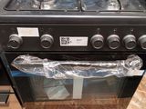 a black stove top oven sitting on top of a wooden table