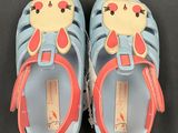 pair of children ' s blue and red shoes with a cat on them