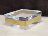 a clear glass box with a gold edge on a wooden table