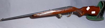 an old gun with a green case on a white surface