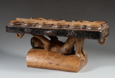 an image of a wooden sculpture of a man holding a large piece of wood
