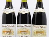 trois bouteilles de vin posées les unes à côté des autres sur une surface blanche