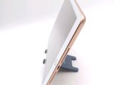 a tablet that is sitting on a stand on a table
