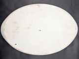 a white plate on a table with a black background