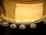 a close up of a gold clock with diamonds on it