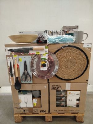 boxes stacked on top of each other in a room with utensils on top of them