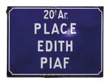 blue sign with white writing on it stating 20 a t place edith piaf