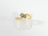 an image of a gold ring with a diamond in the middle
