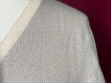 a mannequin wearing a white sweater and tie on a mannequin mannequin