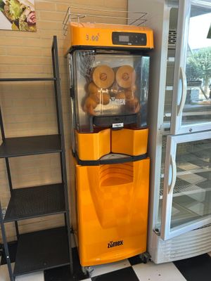 une machine jaune qui se trouve à côté d'un sol à damier noir et blanc