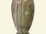 a vase that is sitting on a stand on a white surface