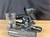 a close up of a camera and a glass on a table