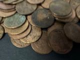 a pile of coins sitting on a black table