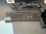 a keyboard and a laptop on a desk with a price tag on it