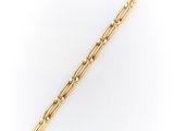 a gold plated bar bracelet with beads on a white background