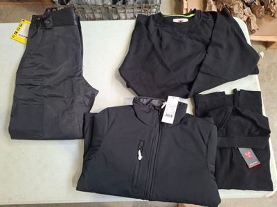 a pile of clothing on a table with a fire place in the background