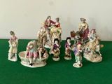 many figurines of people sitting on a green table