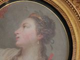painting of a woman in a gold frame with a red ribbon around her neck