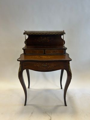 an antique writing desk with a drawer on top of it