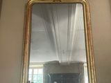 a mirror that is on a mantle in a room