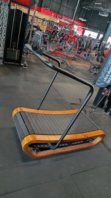 a gym with a tread machine in the middle of the room