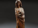 a wooden statue of a woman holding a child