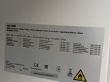 an image of a white machine with a warning sign on it