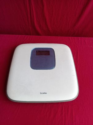 an image of a bathroom scale on a red sheet