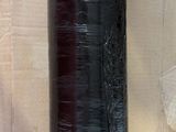 a black spool of yarn sitting on top of a pallet