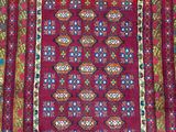 a close up of a red rug with a pattern on it
