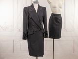 two mannequins and a suit on a mannequin stand