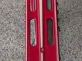 a red scooter that is sitting on the floor