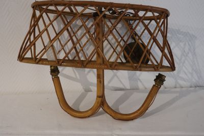 a wicker basket with a lamp on top of it