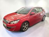 a red car is parked in a white room
