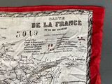 an old map of france on a red pillow