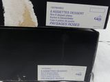 a black box with a label on it sitting on a bed