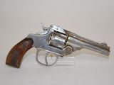 an old revolver with a wooden handle on a white surface