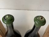 two bottles of wine sitting next to each other on a table