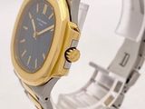 a silver and gold wrist watch with a black face