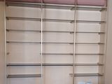 a room that has a shelf and some boxes on the floor