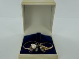 an open box with two rings inside of it on a white surface