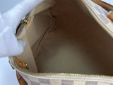 a person holding a handbag with a white handle