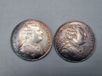 deux pièces d'argent sur lesquelles figurent les portraits d'un homme et d'une femme