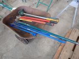 a wheelbarrow full of tools sitting in a wheelbarrow